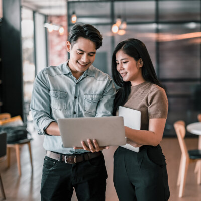 Two young professionals looking through an organisation directory